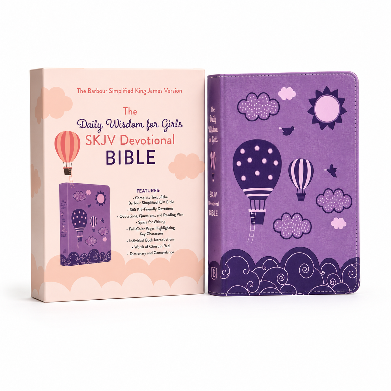 The Daily Wisdom for Girls SKJV Devotional Bible shown next to its pink and purple packaging box on a white background.